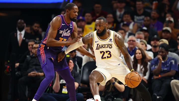 Feb 25, 2024; Phoenix, Arizona, USA; Los Angeles Lakers forward LeBron James (23) against Phoenix Suns forward Kevin Durant (35) at Footprint Center. Mandatory Credit: Mark J. Rebilas-Imagn Images