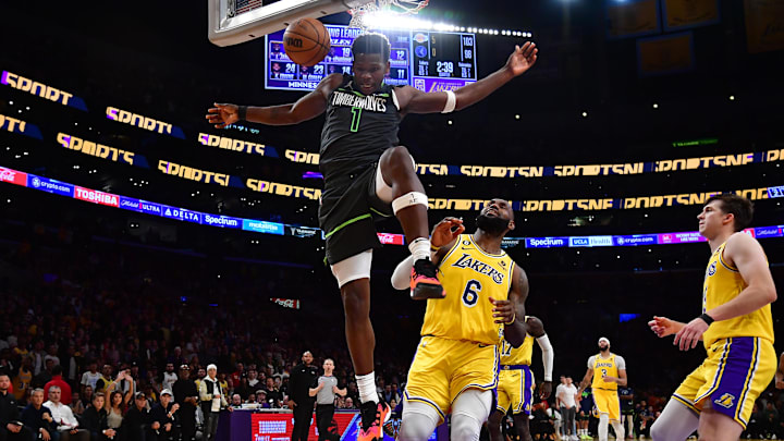 Apr 11, 2023; Los Angeles, California, USA; Minnesota Timberwolves guard Anthony Edwards (1) scores a basket ahead of Los Angeles Lakers forward LeBron James (6) during the second half at Crypto.com Arena. Mandatory Credit: Gary A. Vasquez-Imagn Images