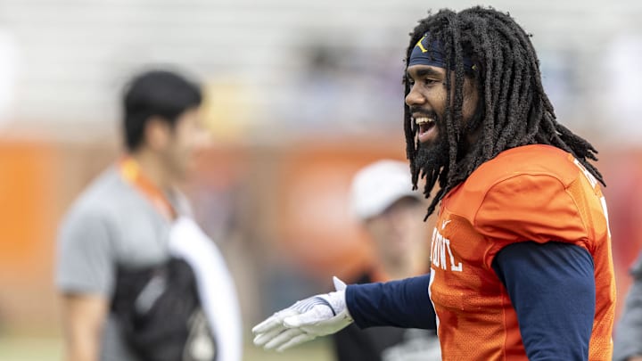 Jan 30, 2025; Mobile, AL, USA; National team running back Donovan Edwards of Michigan (7) celebrates with teammates after a play during Senior Bowl practice for the National team at Hancock Whitney Stadium. Mandatory Credit: Vasha Hunt-Imagn Images