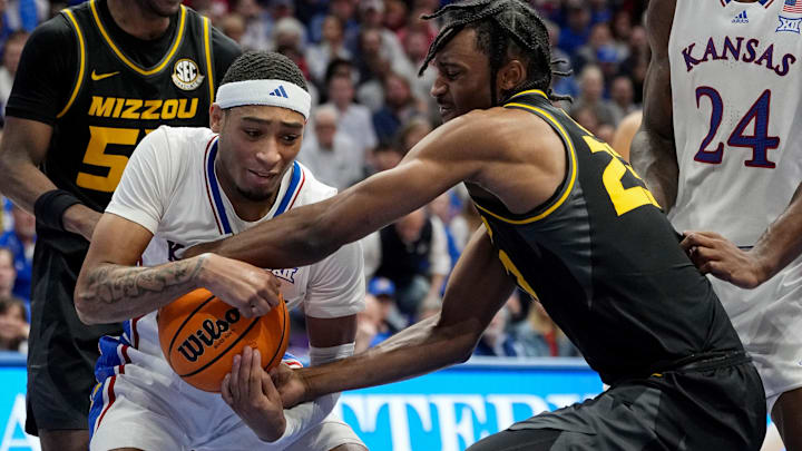 Dec 9, 2023; Lawrence, Kansas, USA; Kansas Jayhawks guard Dajuan Harris Jr. (3) and Missouri Tigers forward Aidan Shaw (23) fight for a loose ball during the second half at Allen Fieldhouse. Mandatory Credit: Jay Biggerstaff-Imagn Images