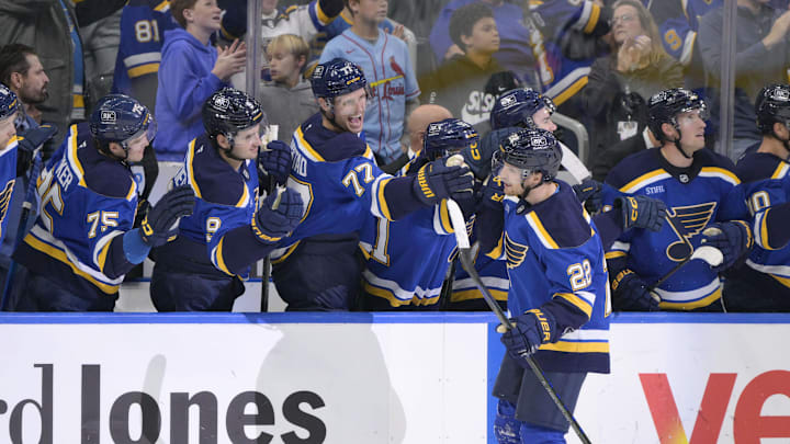 Oct 18, 2025; St. Louis, Missouri, USA; St. Louis Blues center Pius Suter (22) is congratulated by teammates after scoring an empty net goal during the third period at Enterprise Center. Mandatory Credit: Jeff Le-Imagn Images