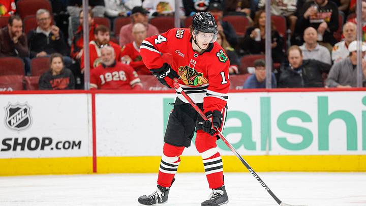 Apr 13, 2026; Chicago, Illinois, USA; Chicago Blackhawks defenseman Kevin Korchinski (14) looks to pass the puck against the Buffalo Sabres during the second period at United Center. Mandatory Credit: Kamil Krzaczynski-Imagn Images