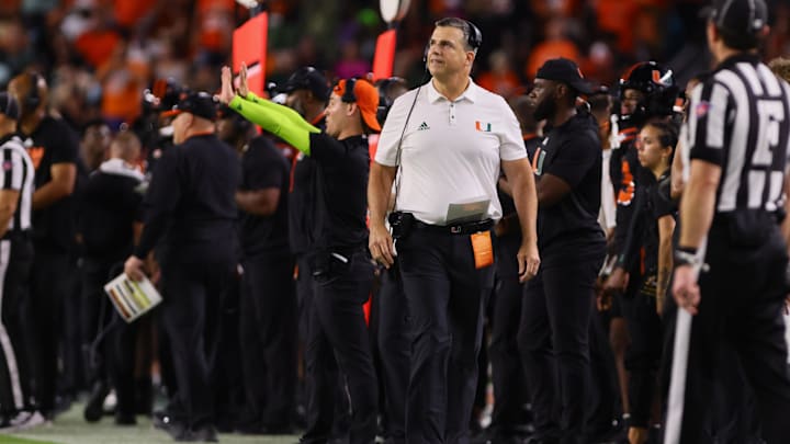 Oct 26, 2024; Miami Gardens, Florida, USA; Miami Hurricanes head coach Mario Cristobal watches from the sideline against the Florida State Seminoles during the third quarter at Hard Rock Stadium. Mandatory Credit: Sam Navarro-Imagn Images