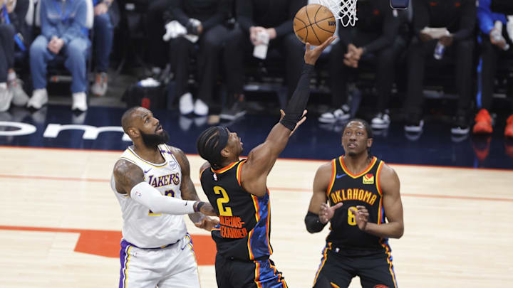 Apr 6, 2025; Oklahoma City, Oklahoma, USA; Oklahoma City Thunder guard Shai Gilgeous-Alexander (2) goes up for a basket in front of Los Angeles Lakers forward LeBron James (23) during the first quarter at Paycom Center. Mandatory Credit: Alonzo Adams-Imagn Images