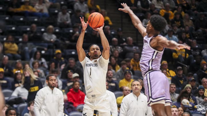 Jan 27, 2026; Morgantown, West Virginia, USA; West Virginia Mountaineers guard Jasper Floyd (1) shoots a three pointer during the second half against the Kansas State Wildcats at Hope Coliseum. Mandatory Credit: Ben Queen-Imagn Imagesa