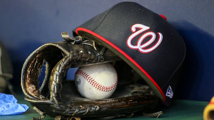 Dark blue Washington Nationals hat on top of a black mitt Dark blue Washington Nationals hat on top of a black mitt