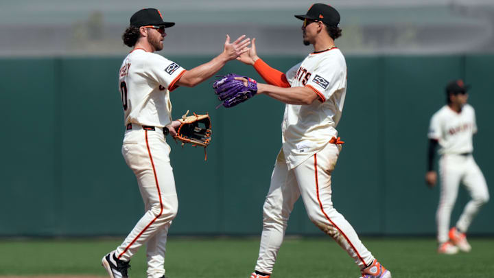 May 3, 2025; San Francisco, California, USA; San Francisco Giants second baseman Brett Wisely (0) and shortstop Willy Adames (right) celebrate after defeating the Colorado Rockies at Oracle Park.