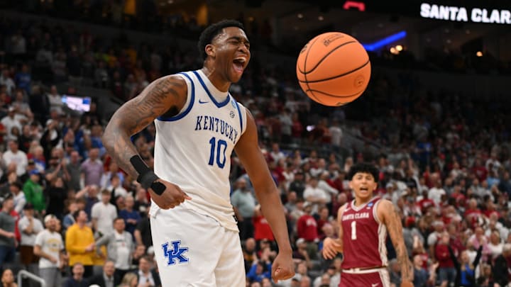 Mar 20, 2026; St. Louis, MO, USA; Kentucky Wildcats forward Brandon Garrison (10) reacts after dunking the ball against Santa Clara Broncos guard Christian Hammond (1) during the overtime period of a first round game of the men's 2026 NCAA Tournament at Enterprise Center. Mandatory Credit: Jeff Curry-Imagn Images