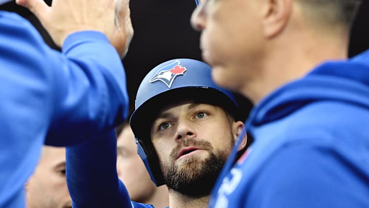 Nathan Lukes of Toronto Blue Jays high fives teammates