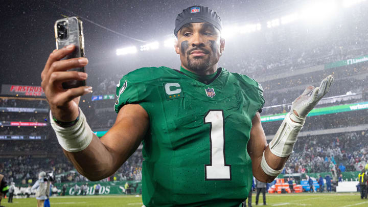 Nov 26, 2023; Philadelphia, Pennsylvania, USA; Philadelphia Eagles quarterback Jalen Hurts (1) reacts with a smart phone while walking off the field after an overtime victory against the Buffalo Bills at Lincoln Financial Field. Mandatory Credit: Bill Streicher-USA TODAY Sports Nov 26, 2023; Philadelphia, Pennsylvania, USA; Philadelphia Eagles quarterback Jalen Hurts (1) reacts with a smart phone while walking off the field after an overtime victory against the Buffalo Bills at Lincoln Financial Field. Mandatory Credit: Bill Streicher-USA TODAY Sports