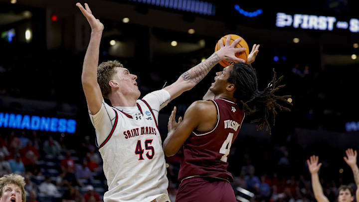 Mar 19, 2026; Oklahoma City, OK, USA; Saint Mary's (CA) Gaels center Andrew McKeever (45) blocks a shot by Texas A&M Aggies forward Jamie Vinson (4) during a first round game of the men's 2026 NCAA Tournament at Paycom Center. Mandatory Credit: Alonzo Adams-Imagn Images