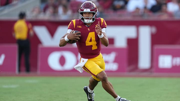 Aug 30, 2025; Los Angeles, California, USA; Southern California Trojans quarterback Husan Longstreet (4) carries the ball against the Missouri State Bears in the second half at United Airlines Field at Los Angeles Memorial Coliseum. Mandatory Credit: Kirby Lee-Imagn Images