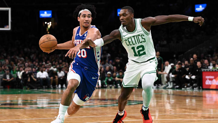 Oct 12, 2024; Boston, Massachusetts, USA; Philadelphia 76ers guard Jared McCain (20) drives to the basket against Boston Celtics guard Lonnie Walker IV (12) during the first half at the TD Garden. Mandatory Credit: Brian Fluharty-Imagn Images