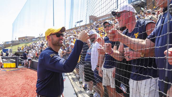 Jun 5, 2026; Morgantown, WV, USA; West Virginia Mountaineers athletic director Wren Baker celebrates with Pat McAfee after defeating the Cal Poly Mustangs at Kendrick Family Ballpark. Mandatory Credit: Ben Queen-Imagn Images