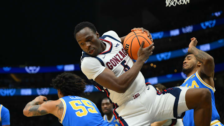 Gonzaga Bulldogs forward Emmanuel Innocenti (5) rebounds the ball over UCLA Bruins guard Skyy Clark (55) during the first half at Climate Pledge Arena. Gonzaga Bulldogs forward Emmanuel Innocenti (5) rebounds the ball over UCLA Bruins guard Skyy Clark (55) during the first half at Climate Pledge Arena.