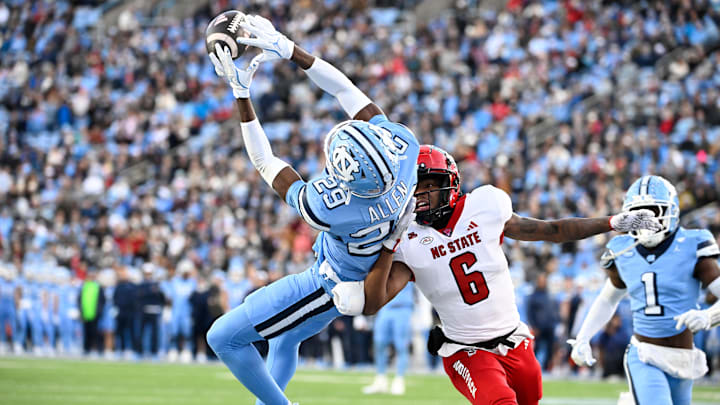 Nov 30, 2024; Chapel Hill, North Carolina, USA; North Carolina Tar Heels defensive back Marcus Allen (29) intercepts the ball in the end zone intended for North Carolina State Wolfpack wide receiver Wesley Grimes (6) in the first quarter at Kenan Memorial Stadium. Mandatory Credit: Bob Donnan-Imagn Images