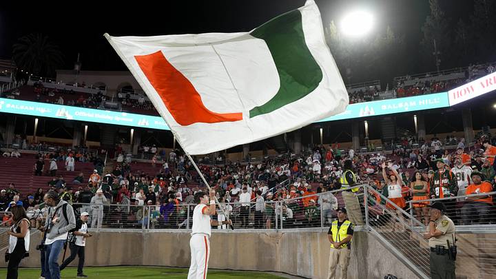 Sep 4, 2026; Stanford, California, USA;  A Miami Hurricanes cheerleader waves a flag during the fourth quarter against the Stanford Cardinal at Stanford Stadium.  Mandatory Credit: Stan Szeto-Imagn Images