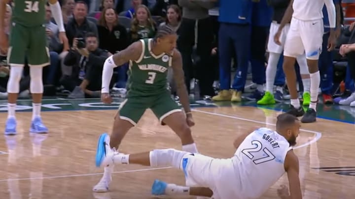 Kevin Porter Jr. stands over Rudy Gobert with his fist clenched. Kevin Porter Jr. stands over Rudy Gobert with his fist clenched.