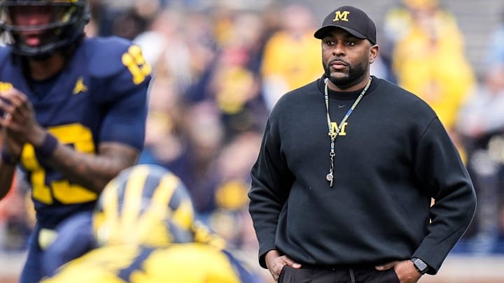 Michigan head coach Sherrone Moore watches a play behind quarterback Bryce Underwood (19) during the second half of the spring game at Michigan Stadium. Michigan head coach Sherrone Moore watches a play behind quarterback Bryce Underwood (19) during the second half of the spring game at Michigan Stadium.