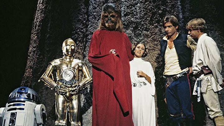 (L to r) R2-D2, Anthony Daniels as C-3PO, Peter Mayhew as Chewbacca, Carrie Fisher as Princess Leia, Harrison Ford as Han Solo, and Mark Hamill as Luke Skywalker in the Star Wars Holiday Special