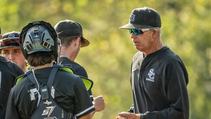 Sierra Canyon baseball coach Tom Meusborn addresses his team during a game.