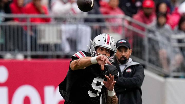 Quarterback Tavien St. Clair (9) makes a pass as head coach Ryan Day watches in the background in the second half of the Ohio State football spring game at Ohio Stadium on Saturday, April 18, 2026 in Columbus, Ohio. Quarterback Tavien St. Clair (9) makes a pass as head coach Ryan Day watches in the background in the second half of the Ohio State football spring game at Ohio Stadium on Saturday, April 18, 2026 in Columbus, Ohio.