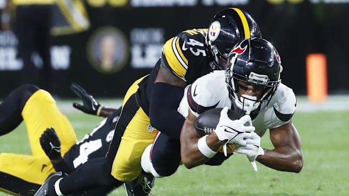 Aug 9, 2024; Pittsburgh, Pennsylvania, USA; Houston Texans wide receiver Johnny Johnson III (front) dives for additional yardage as Pittsburgh Steelers linebacker Jacoby Windmon (45) defends during the fourth quarter at Acrisure Stadium. Houston won 20-12. Mandatory Credit: Charles LeClaire-Imagn Images Aug 9, 2024; Pittsburgh, Pennsylvania, USA; Houston Texans wide receiver Johnny Johnson III (front) dives for additional yardage as Pittsburgh Steelers linebacker Jacoby Windmon (45) defends during the fourth quarter at Acrisure Stadium. Houston won 20-12. Mandatory Credit: Charles LeClaire-Imagn Images