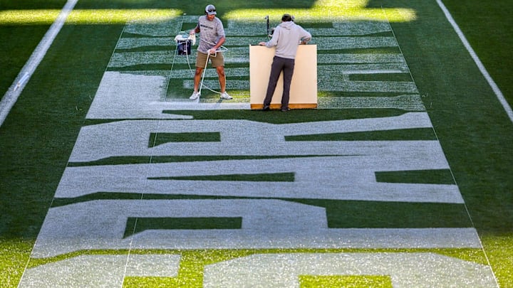 Michigan State University Assistant Sports Turf Manager Brian McDougal, left, and student assistant