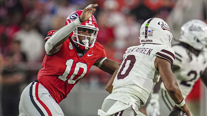 Oct 12, 2024; Athens, Georgia, USA; Georgia Bulldogs linebacker Damon Wilson II (10) tries to tackle Mississippi State Bulldogs quarterback Michael Van Buren Jr. (0) at Sanford Stadium. Mandatory Credit: Dale Zanine-Imagn Images