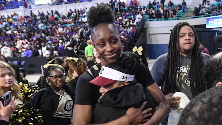 Dawn Staley, Head coach of the University of South Carolina basketball team, hugs Gamecocks signee Joyce Edwards
