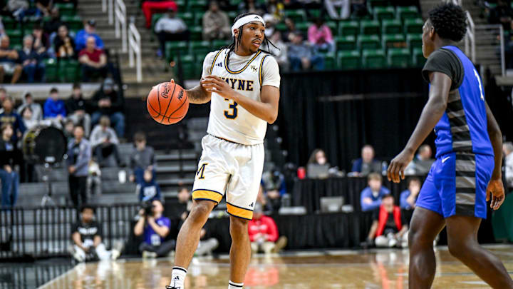 Wayne Memorial's Carlos Medlock Jr. moves the ball against Flint Carman-Ainsworth during the second quarter in the Division 1 state semifinal on Friday, March 14, 2025, at the Breslin Center in East Lansing.
