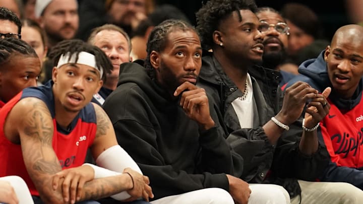 Dec 21, 2024; Dallas, Texas, USA;  Kawhi Leonard looks on from the bench in street clothes during the game against the Dallas Mavericks during the second half at American Airlines Center. Mandatory Credit: Chris Jones-Imagn Images