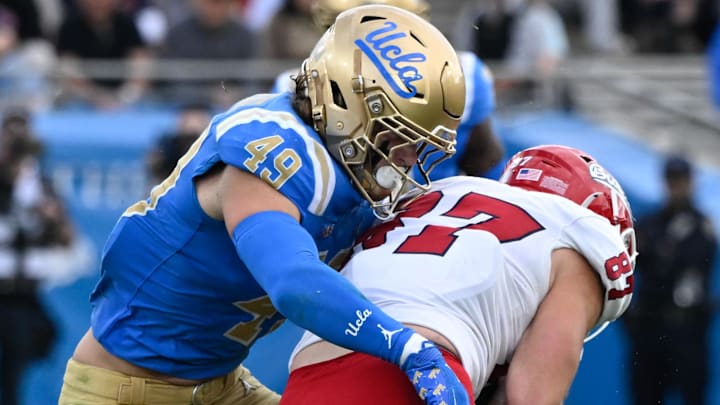 Nov 30, 2024; Pasadena, California, USA; UCLA Bruins linebacker Carson Schwesinger (49) Fresno State Bulldogs tight end Jake Tarwater (87) during the third quarter at Rose Bowl. Mandatory Credit: Robert Hanashiro-Imagn Images
