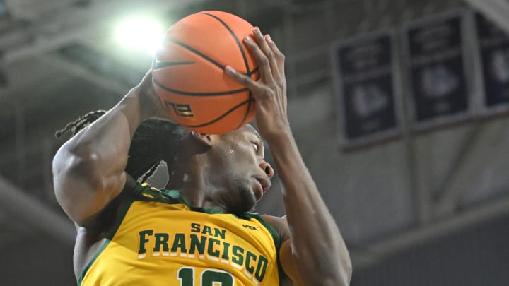 Jan 25, 2024; Spokane, Washington, USA; San Francisco Dons forward Jonathan Mogbo (10) rebounds the ball 
against the Gonzaga Bulldogs in the first half at McCarthey Athletic Center. Mandatory Credit: James Snook-USA TODAY Sports