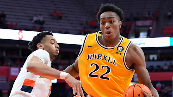 Nov 14, 2021; Syracuse, New York, USA; Drexel Dragons forward Amari Williams (22) drives to the basket against the defense of Syracuse Orange center Frank Anselem (left) during the first half at the Carrier Dome. Mandatory Credit: Rich Barnes-Imagn Images