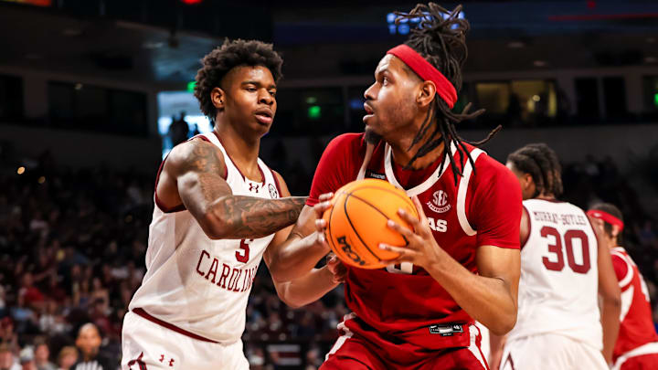 Mar 1, 2025; Columbia, South Carolina, USA; Arkansas Razorbacks forward Jonas Aidoo (9) looks to shoot over South Carolina Gamecocks forward Nick Pringle (5) in the second half at Colonial Life Arena. Mandatory Credit: Jeff Blake-Imagn Images