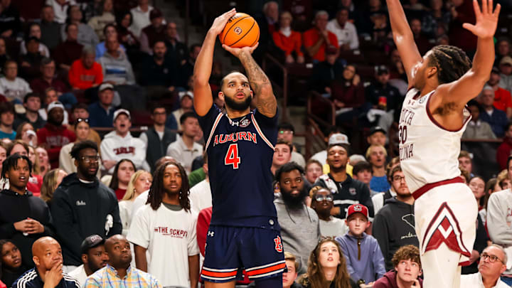 Jan 11, 2025; Columbia, South Carolina, USA; Auburn Tigers forward Johni Broome (4) attempts a three point basket over South Carolina Gamecocks forward Collin Murray-Boyles (30) in the second half at Colonial Life Arena. Mandatory Credit: Jeff Blake-Imagn Images
