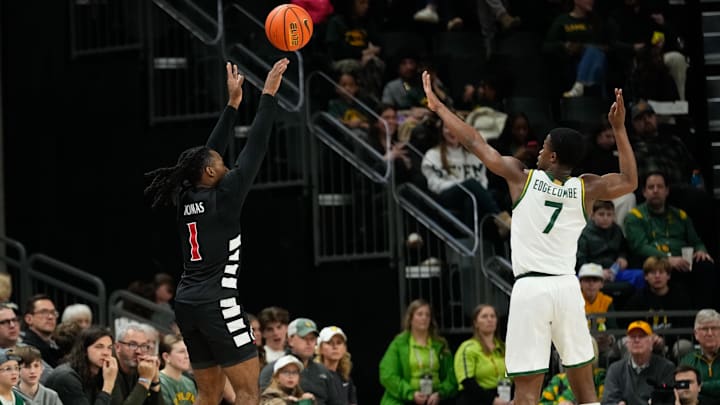 Jan 7, 2025; Waco, Texas, USA;  Cincinnati Bearcats guard Day Day Thomas (1) scores a three-point basket against Baylor Bears guard VJ Edgecombe (7) during the first half at Paul and Alejandra Foster Pavilion. Mandatory Credit: Chris Jones-Imagn Images