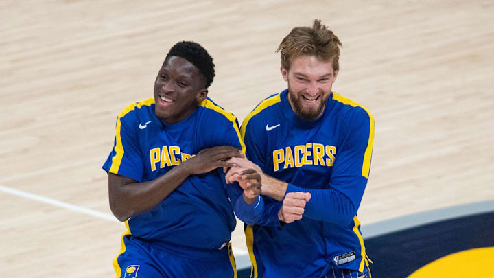Dec 31, 2020; Indianapolis, Indiana, USA; Indiana Pacers forward Domantas Sabonis (11) and guard Victor Oladipo (4) share a laugh during warm ups before the game against the Cleveland Cavaliers in the first quarter at Bankers Life Fieldhouse. Mandatory Credit: Trevor Ruszkowski-Imagn Images
