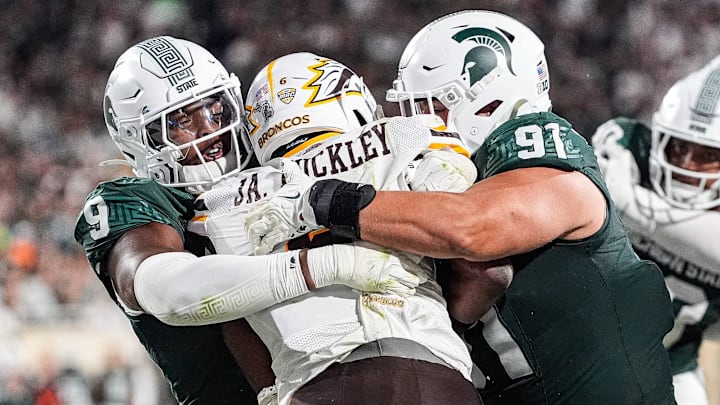 Michigan State defensive lineman Jalen Thompson (9), left, and defensive lineman Alex VanSumeren (91) tackle Western Michigan running back Jalen Buckley (6) for a safety during the second half at Spartan Stadium in East Lansing on Friday, August 29, 2025.