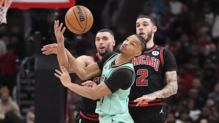 Dec 13, 2024; Chicago, Illinois, USA; Charlotte Hornets guard Isaiah Wong (21) fights for a loose ball against Chicago Bulls guard Zach LaVine (8) and guard Lonzo Ball (2) during the first half at the United Center. Mandatory Credit: Matt Marton-Imagn Images