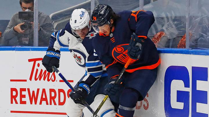 May 19, 2021; Edmonton, Alberta, CAN; Edmonton Oilers defensemen Ethan Bear (74) and Winnipeg Jets forward Andrew Copp (9) battle along the boards for a loose puck during the second period in game one of the first round of the 2021 Stanley Cup Playoffs at Rogers Place. Mandatory Credit: Perry Nelson-USA TODAY Sports May 19, 2021; Edmonton, Alberta, CAN; Edmonton Oilers defensemen Ethan Bear (74) and Winnipeg Jets forward Andrew Copp (9) battle along the boards for a loose puck during the second period in game one of the first round of the 2021 Stanley Cup Playoffs at Rogers Place. Mandatory Credit: Perry Nelson-USA TODAY Sports