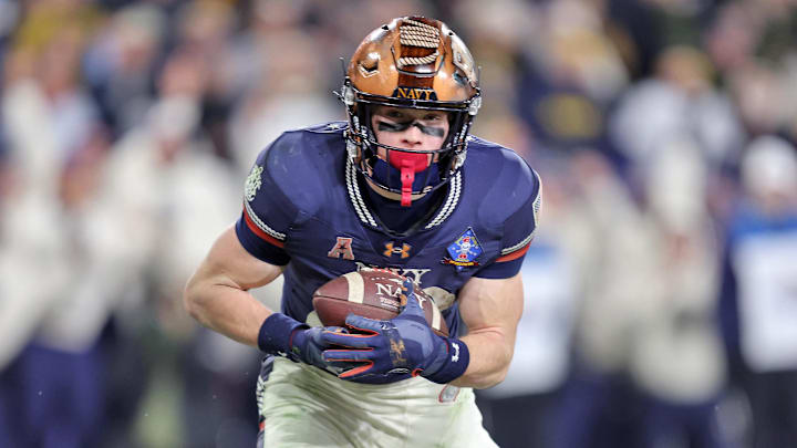 Dec 13, 2025; Baltimore, Maryland, USA; Navy Midshipmen slotback Eli Heidenreich (22) catches a pass for a touchdown against the Army Black Knights during the second half of the 126th Army-Navy game at M&T Bank Stadium. Mandatory Credit: Danny Wild-Imagn Images