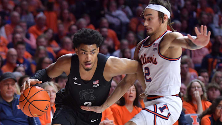 Feb 15, 2025; Champaign, Illinois, USA;  Michigan State Spartans guard Jaden Akins (3) drives the ball past Illinois Fighting Illini guard Dra Gibbs-Lawhorn (2) during the second half at State Farm Center. Mandatory Credit: Ron Johnson-Imagn Images