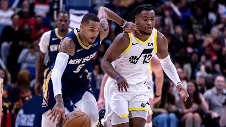 Jan 17, 2025; New Orleans, Louisiana, USA; New Orleans Pelicans guard Dejounte Murray (5) brings the ball up court against Utah Jazz guard Isaiah Collier (13) during the first half at Smoothie King Center. Mandatory Credit: Stephen Lew-Imagn Images