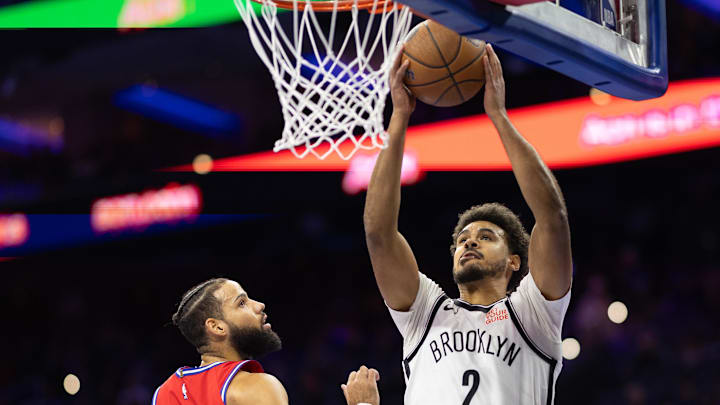 Nov 22, 2024; Philadelphia, Pennsylvania, USA; Brooklyn Nets forward Cameron Johnson (2) drives for a shot past Philadelphia 76ers forward Caleb Martin (16) during the first quarter at Wells Fargo Center. Mandatory Credit: Bill Streicher-Imagn Images