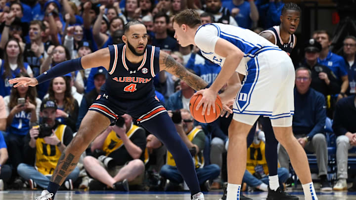 Dec 4, 2024; Durham, North Carolina, USA; Duke Blue Devils forward Cooper Flagg (2) controls the ball in front of Auburn Tigers center Johni Broome (4) during the first half at Cameron Indoor Stadium. Mandatory Credit: Rob Kinnan-Imagn Images