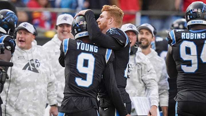 Nov 24, 2024; Charlotte, North Carolina, USA; Carolina Panthers quarterback Bryce Young (9) is congratulated by quarterback Andy Dalton (14) after his touchdown drive against the Kansas City Chiefs during the second half at Bank of America Stadium. Mandatory Credit: Jim Dedmon-Imagn Images Nov 24, 2024; Charlotte, North Carolina, USA; Carolina Panthers quarterback Bryce Young (9) is congratulated by quarterback Andy Dalton (14) after his touchdown drive against the Kansas City Chiefs during the second half at Bank of America Stadium. Mandatory Credit: Jim Dedmon-Imagn Images