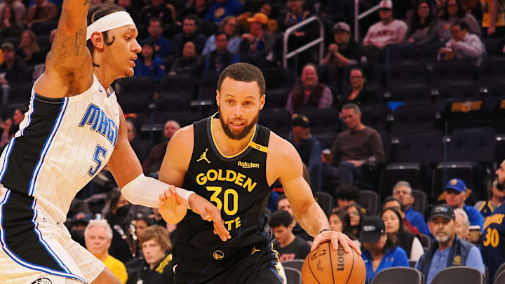 Golden State Warriors guard Stephen Curry (30) drives in against Orlando Magic forward Paolo Banchero (5) during the third quarter at Chase Center.