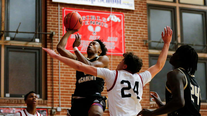 Link Academy's Tre Johnson goes up for a field goal attempt as the Lions took on the Central Bulldogs in The Pit at Central High School on Tuesday, Nov. 28, 2023.
